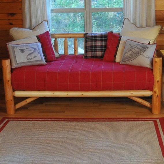 rustic cedar log daybed with red blanket and pillows